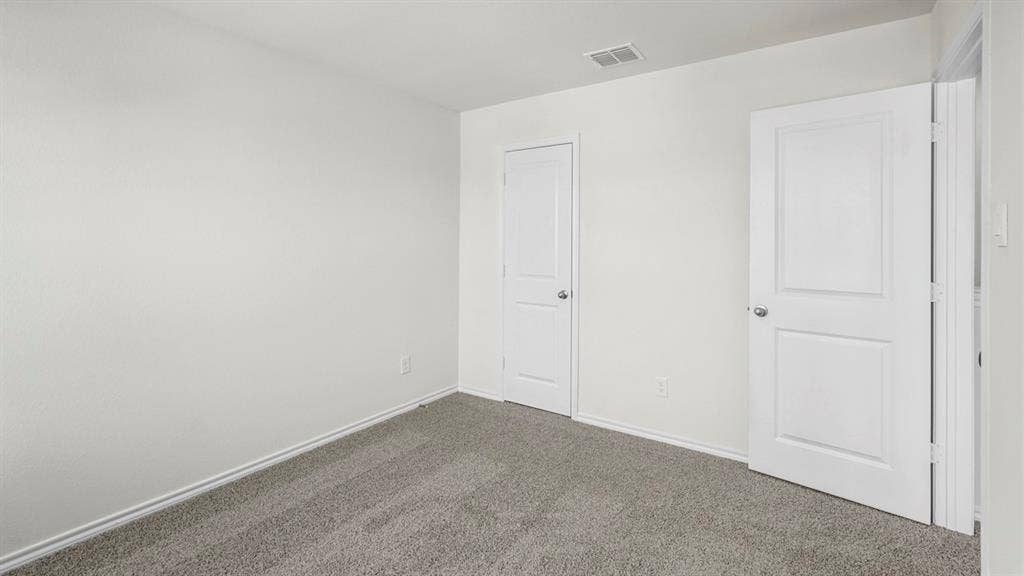 1671 Blaire Drive, Tyler, TX 75702 Textured walls with neutral paint, gray carpeting, and white paneled doors