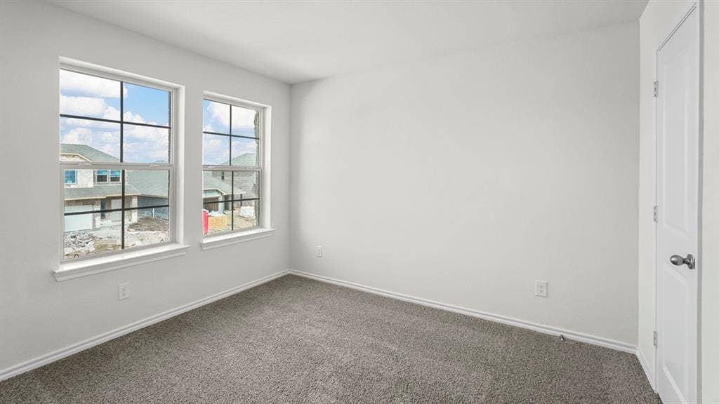 1671 Blaire Drive, Tyler, TX 75702 Light gray carpeting, white painted walls, and two large windows with white trim