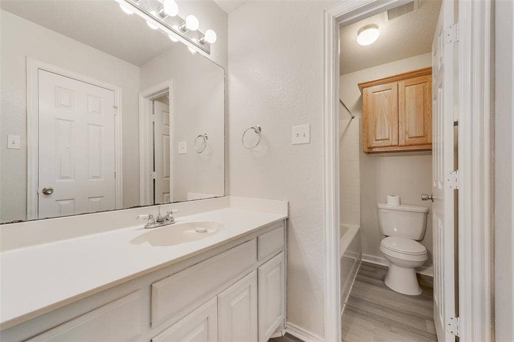220 Hollywood Drive, Glenn Heights, TX 75154 White vanity with an integrated sink and chrome faucet