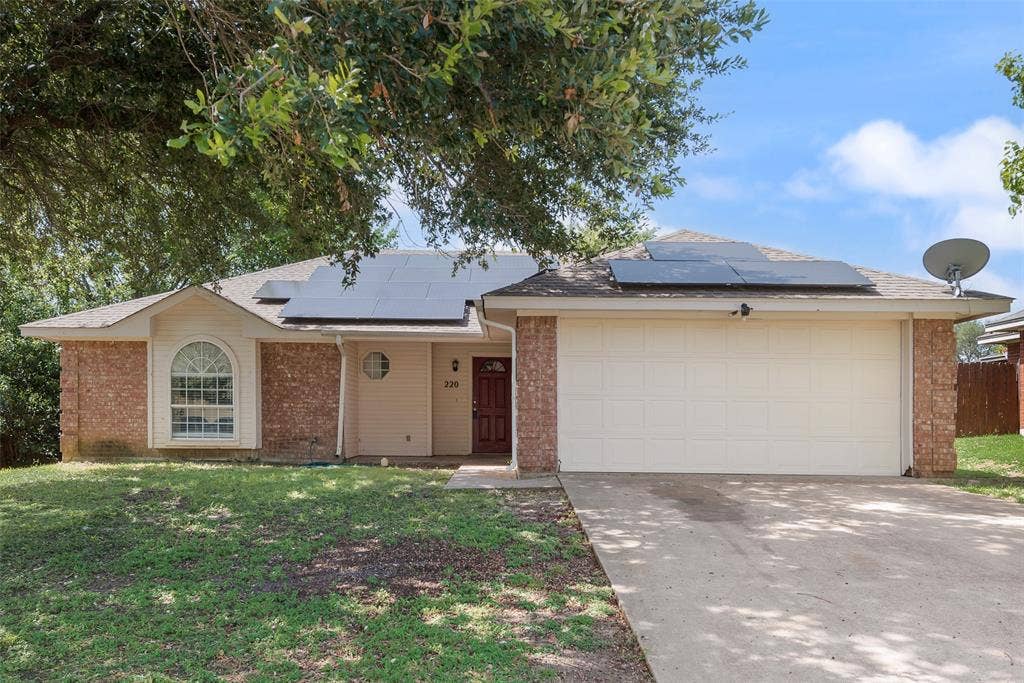 220 Hollywood Drive, Glenn Heights, TX 75154 Brick and siding exterior with a single-car garage and concrete driveway