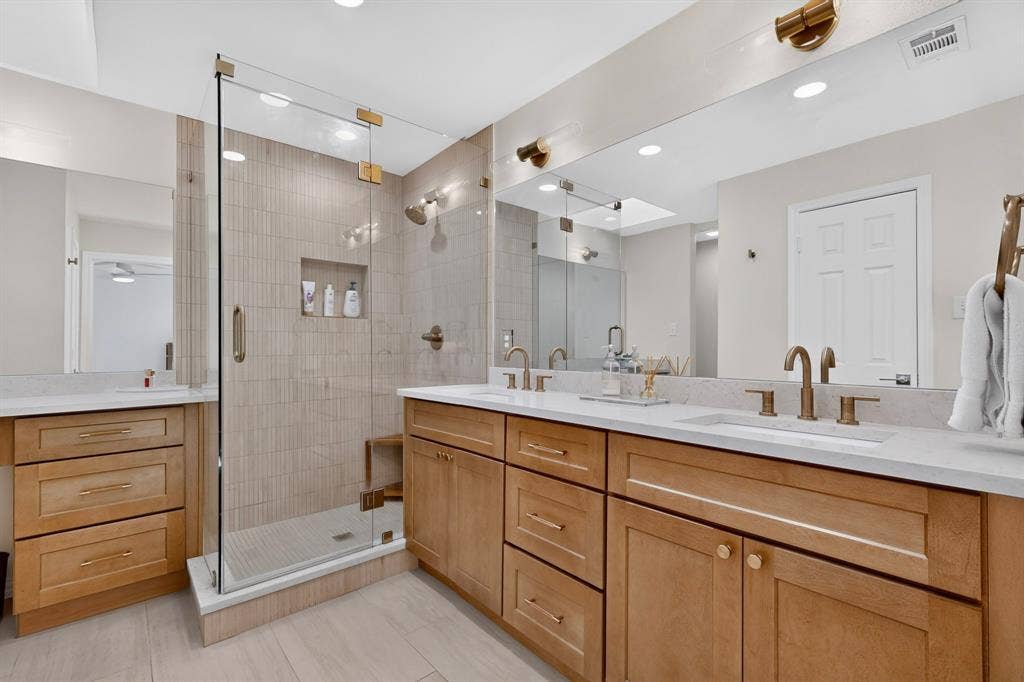 17335 Remington Park Place, Dallas, TX 75252 Dual vanity with integrated sinks, quartz countertops, and brushed brass fixtures