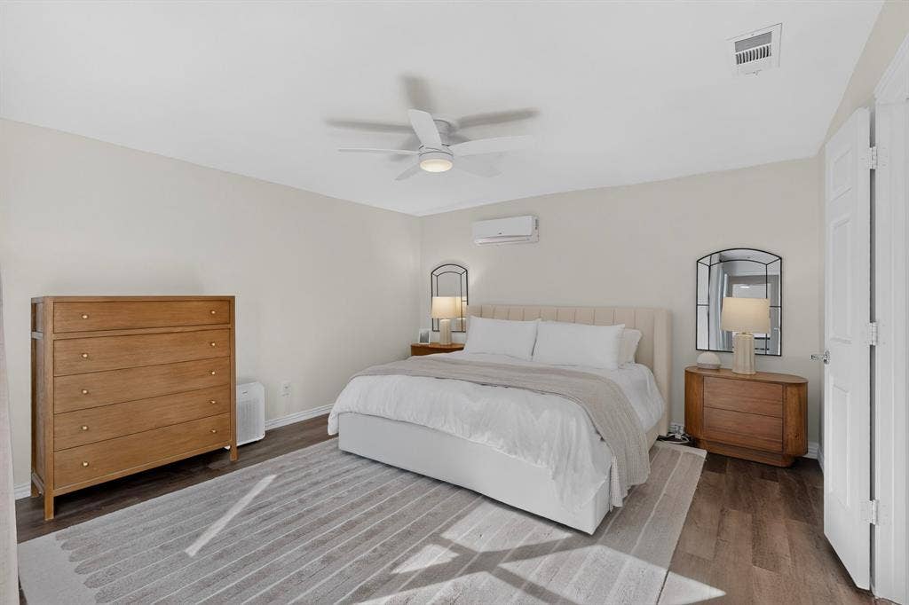 17335 Remington Park Place, Dallas, TX 75252 Wood-finish flooring with light-toned walls, featuring a ceiling fan with integrated lighting