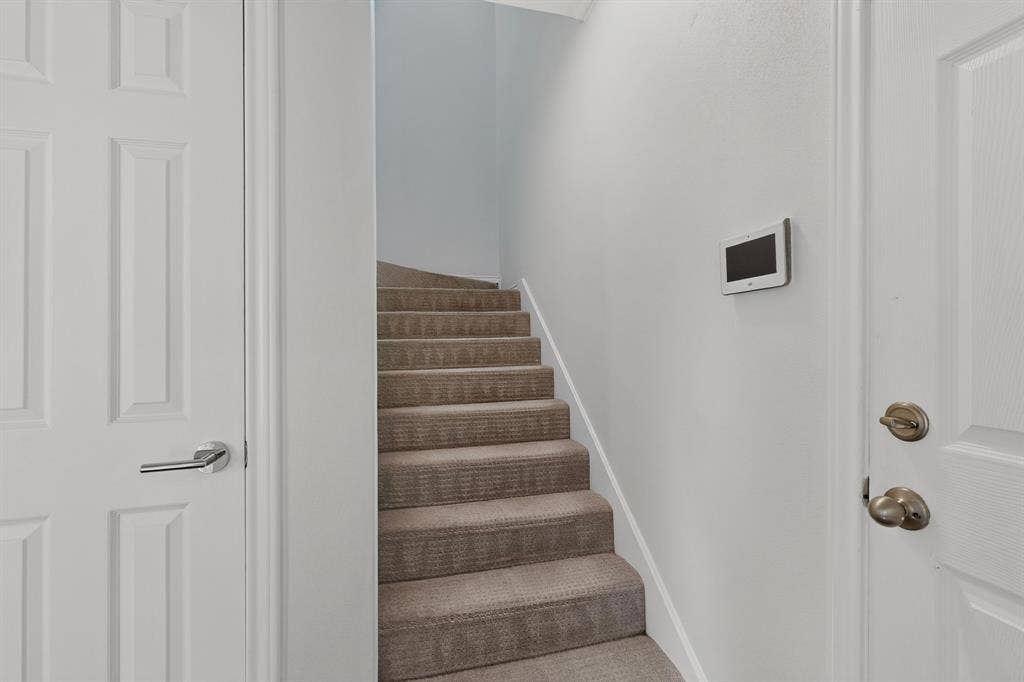 17335 Remington Park Place, Dallas, TX 75252 Carpeted staircase with white risers and a light-colored wall
