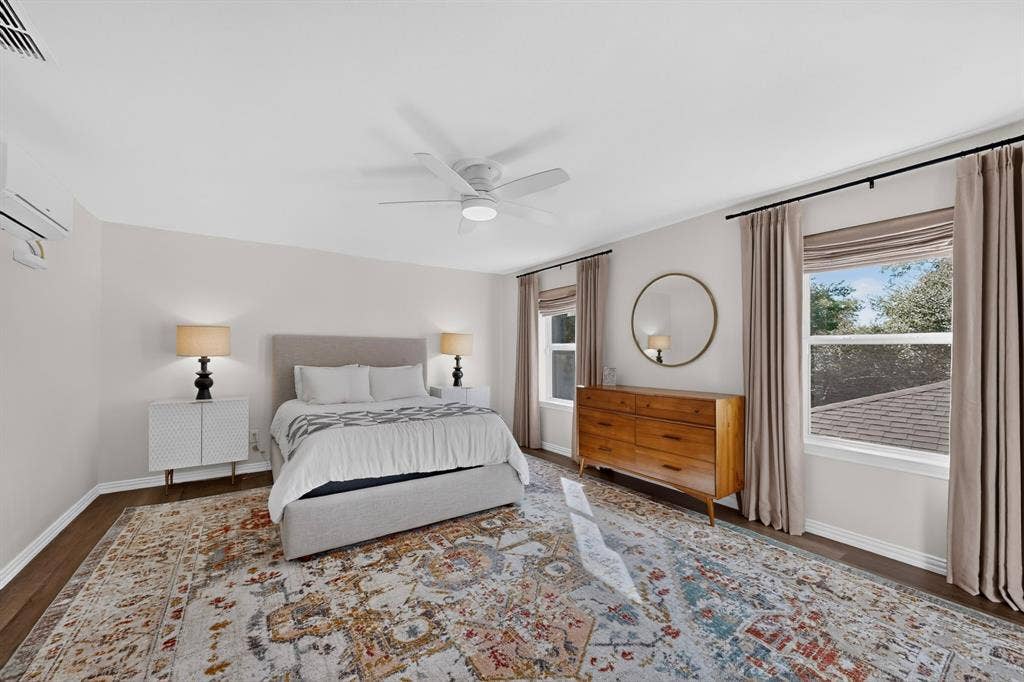 17335 Remington Park Place, Dallas, TX 75252 Wood-finish flooring, ceiling fan, split air conditioning unit, and multiple windows with privacy blinds
