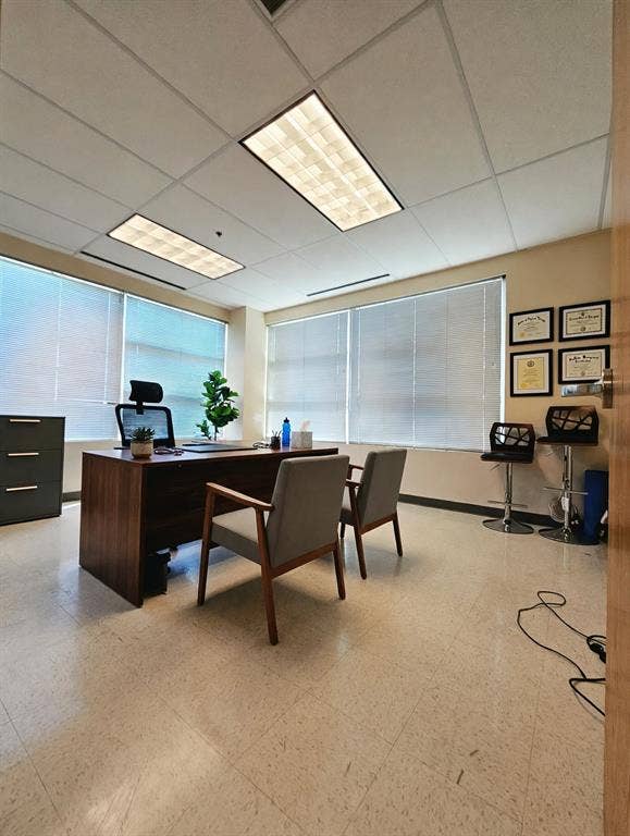 1675 Republic Parkway, #140, Mesquite, TX 75150 Recessed fluorescent lighting, large windows with horizontal blinds, light-toned flooring, and a solid-core door