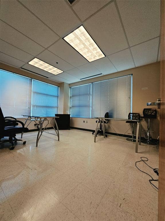 1675 Republic Parkway, #140, Mesquite, TX 75150 Fluorescent overhead lighting, drop ceiling, multiple windows with horizontal blinds, light-toned tile flooring, and neutral wall paint
