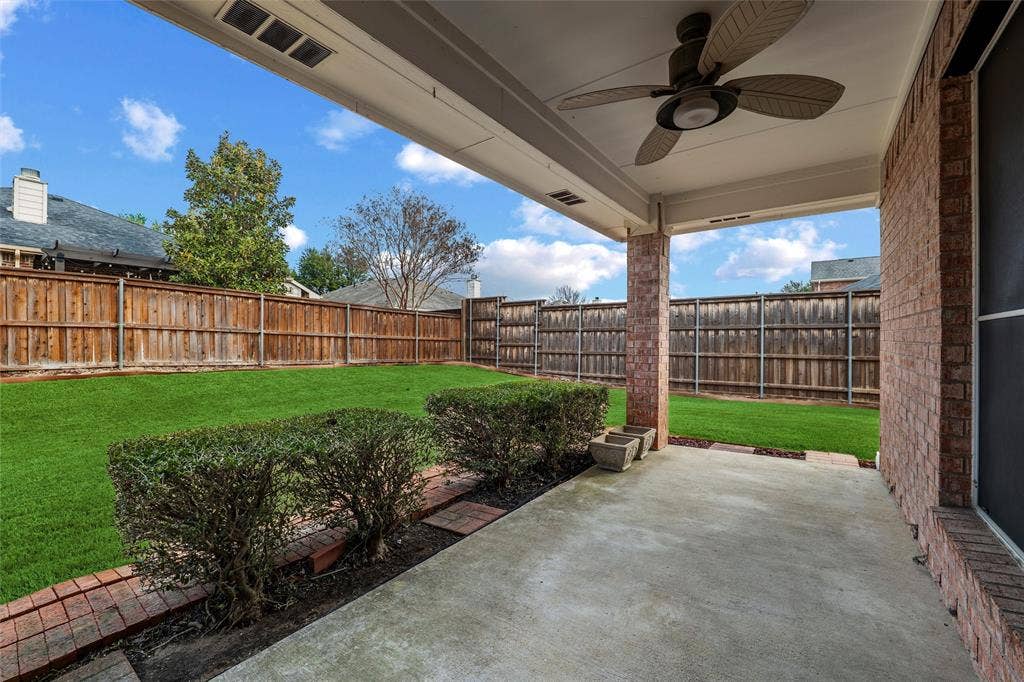 Oversized covered patio ideal for relaxing or entertaining, complete with ceiling fan and easy access to the backyard.