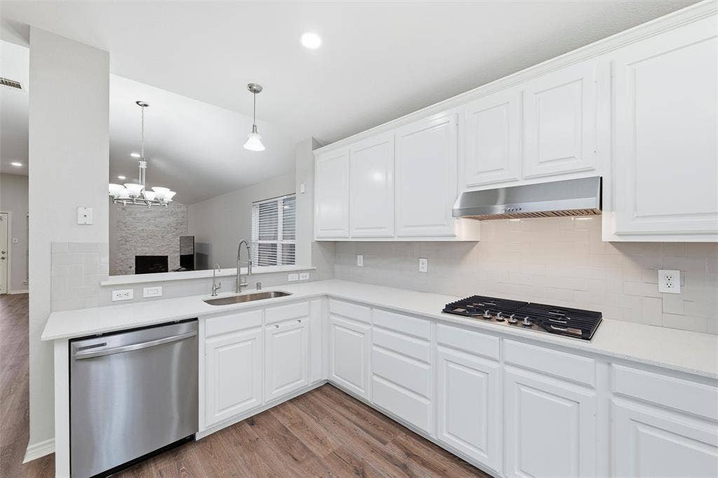 Thoughtfully updated workspace featuring a new sink, quartz counters, stainless steel dishwasher, and under-sink reverse osmosis system.