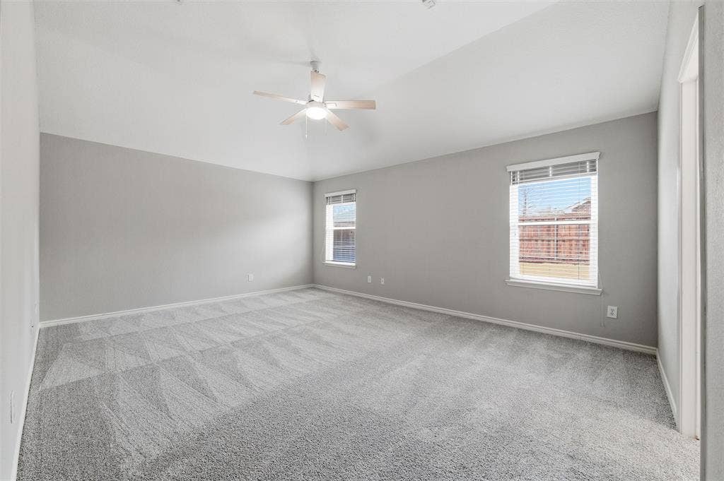 Retreat to a spacious primary suite with vaulted ceilings, new carpet, and a beautifully updated ensuite bath.