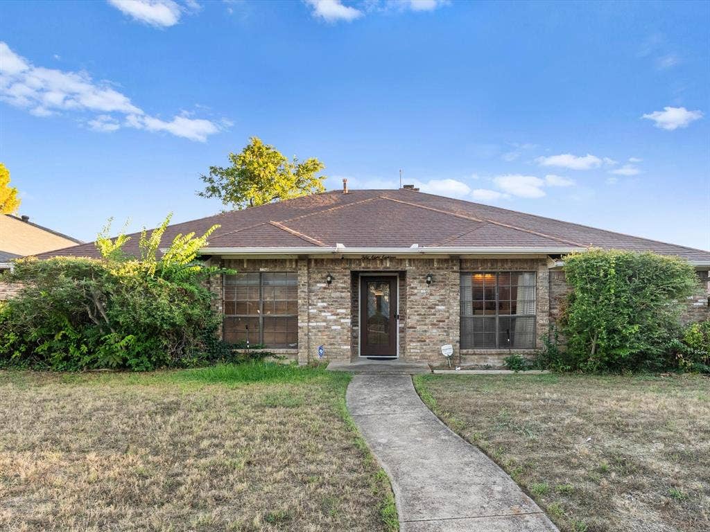 5818 Winding Woods Trail, Dallas, TX 75227 Brick exterior with a brown shingle roof.