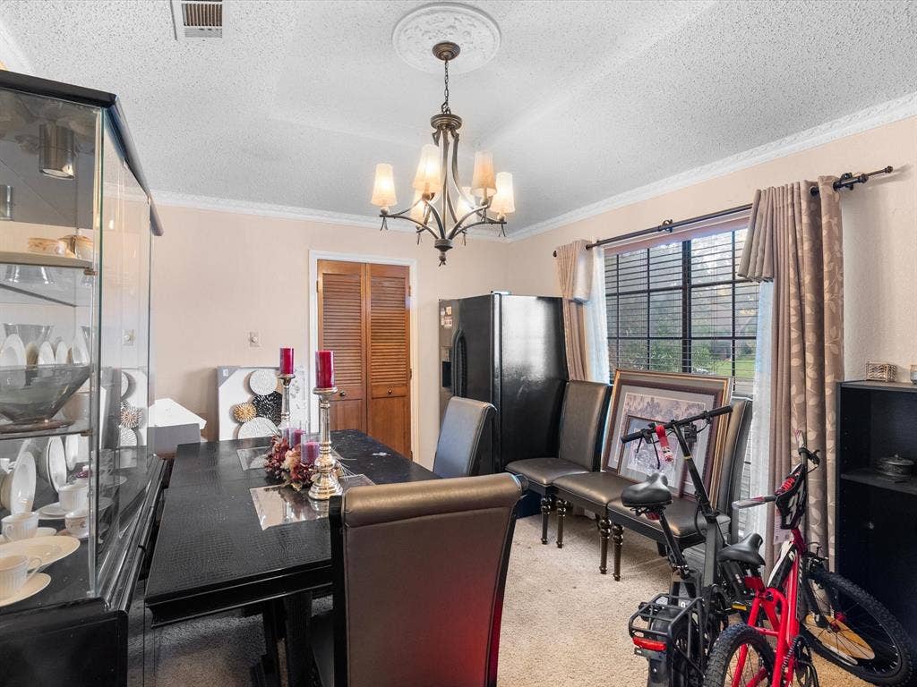 5818 Winding Woods Trail, Dallas, TX 75227 Recessed ceiling with decorative medallion, classic chandelier, crown molding, and window with blinds