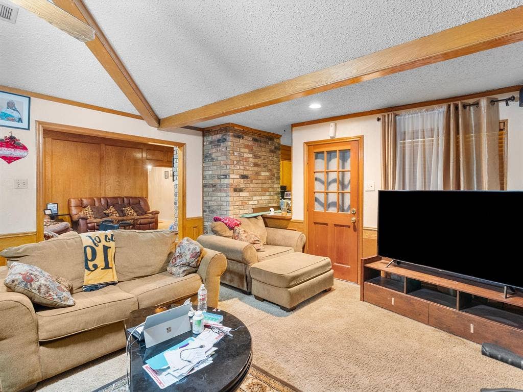 5818 Winding Woods Trail, Dallas, TX 75227 Exposed ceiling beams, brick accent wall, wood-paneled wall, wood-finish interior door with glass inserts, recessed lighting