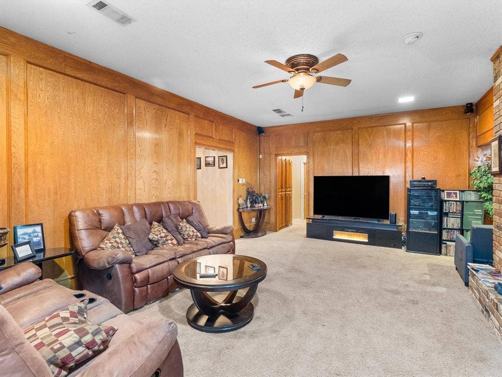 5818 Winding Woods Trail, Dallas, TX 75227 Wood paneling throughout, ceiling fan with integrated lighting, recessed lighting, and carpeted flooring
