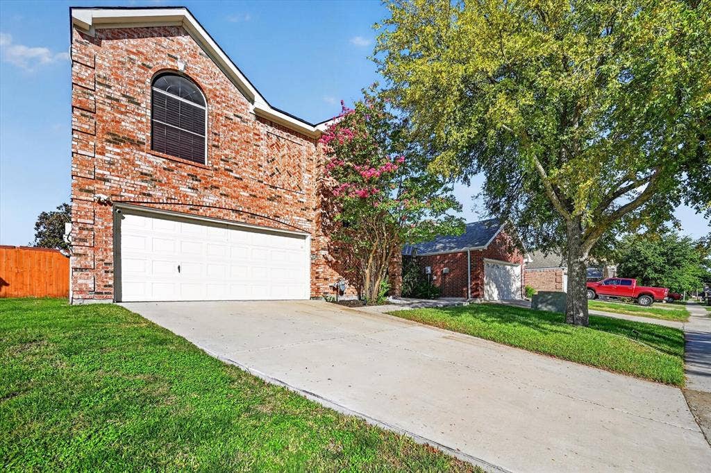 1825 Bachman Court, Plano, TX 75075 Brick exterior with arched window and white garage door