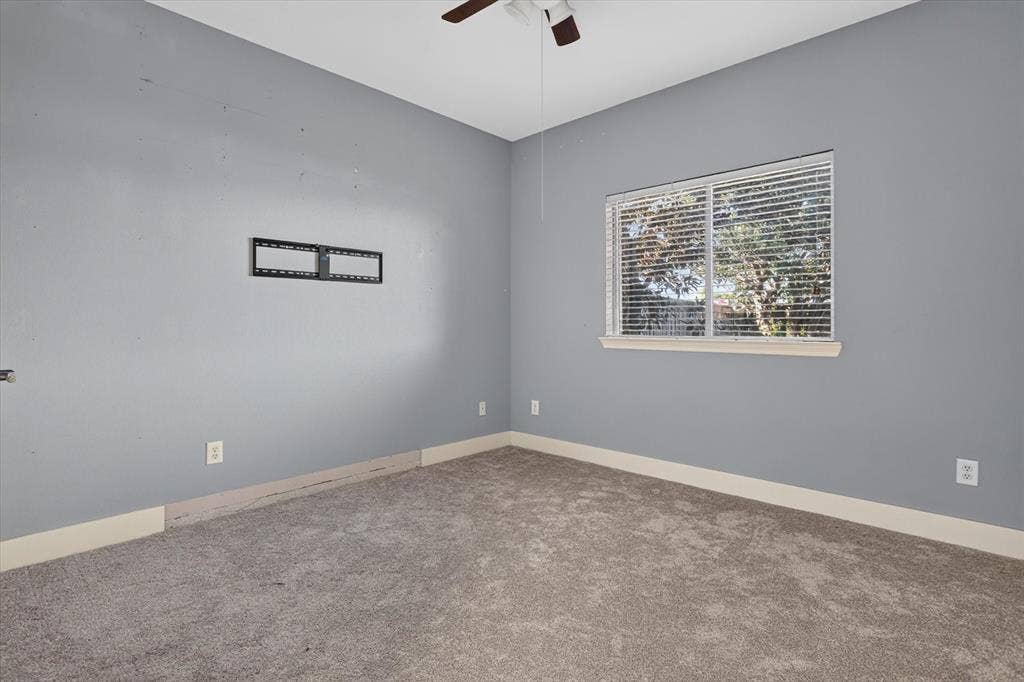 1825 Bachman Court, Plano, TX 75075 Neutral-toned wall paint, neutral carpeting, horizontal window blinds, and ceiling fan with integrated lighting