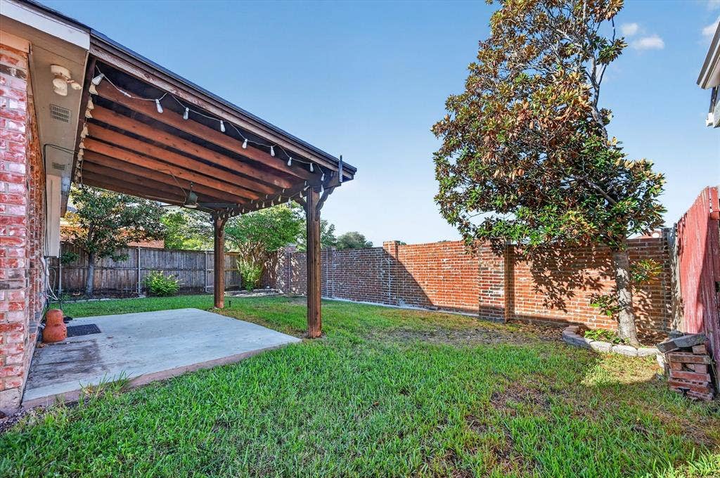 1825 Bachman Court, Plano, TX 75075 Covered patio featuring a wood-beam ceiling, concrete slab, and brick exterior
