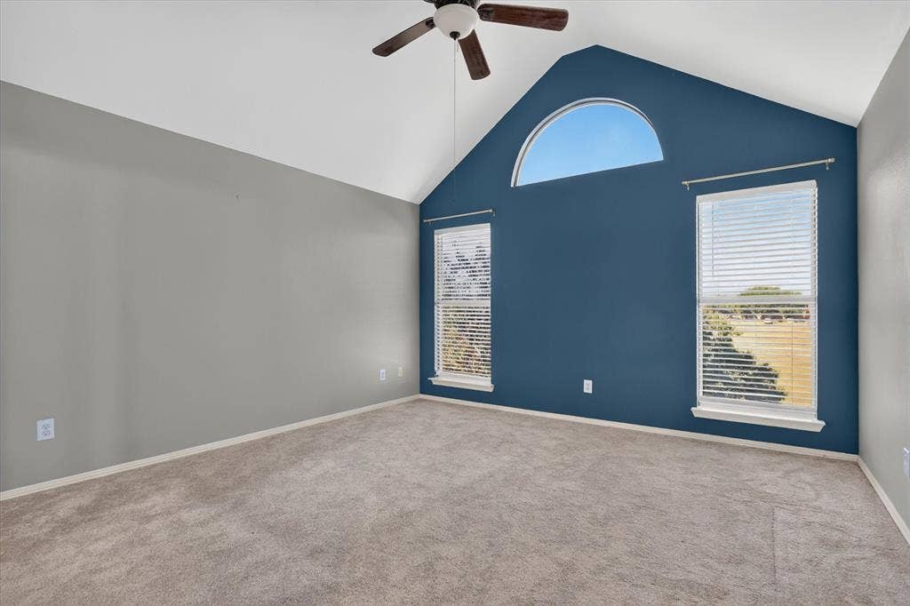 1825 Bachman Court, Plano, TX 75075 Vaulted ceiling with a central paddle fan, accented by an arched window and two additional vertical windows