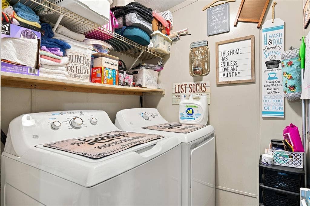 365 Beaver Lane, Waco, TX 76705 White washer and dryer units with overhead shelving and a wall-mounted shelf
