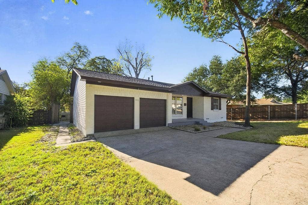 9112 Clearwater Drive, Dallas, TX 75243 White painted brick facade with brown trim