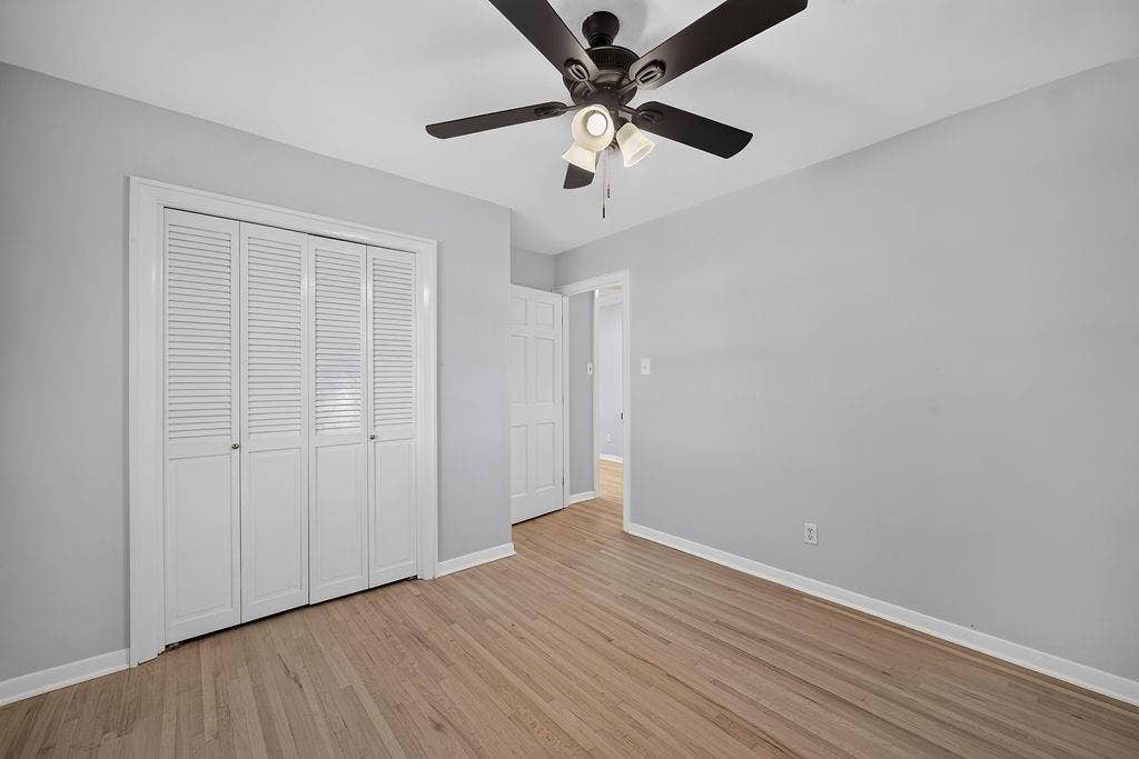9112 Clearwater Drive, Dallas, TX 75243 Light wood-finish flooring with white baseboards