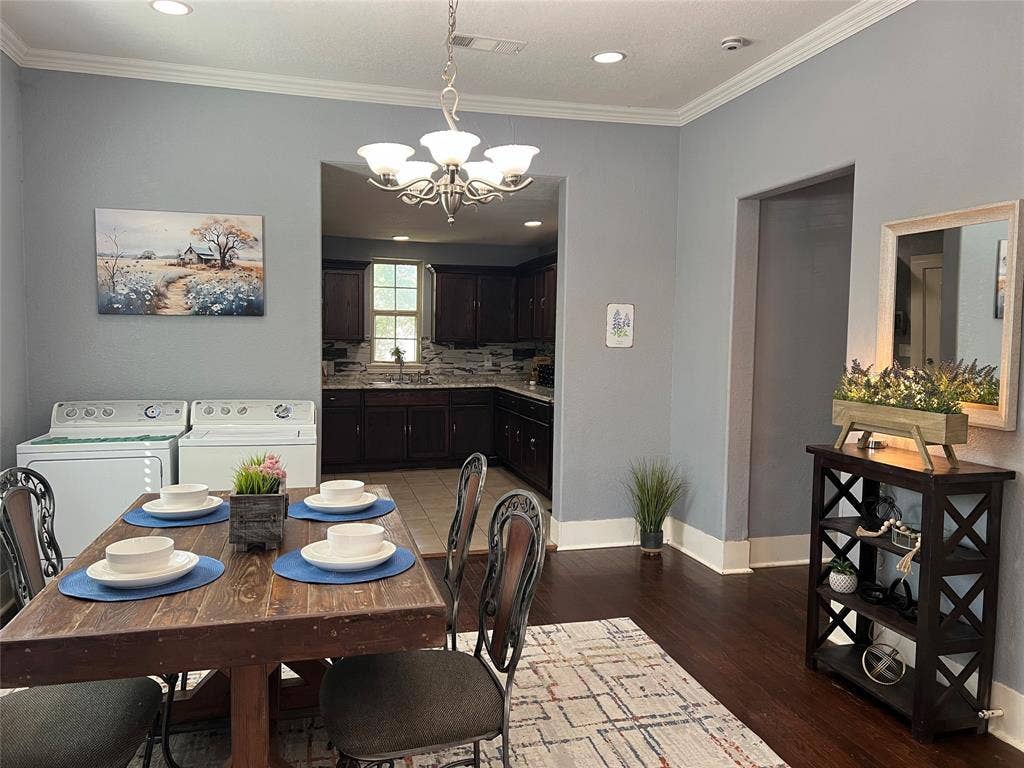 3227 Avenue I, Fort Worth, TX 76105 Recessed ceiling lighting, crown molding, wood-finish flooring, a contemporary chandelier, and a built-in shelving unit