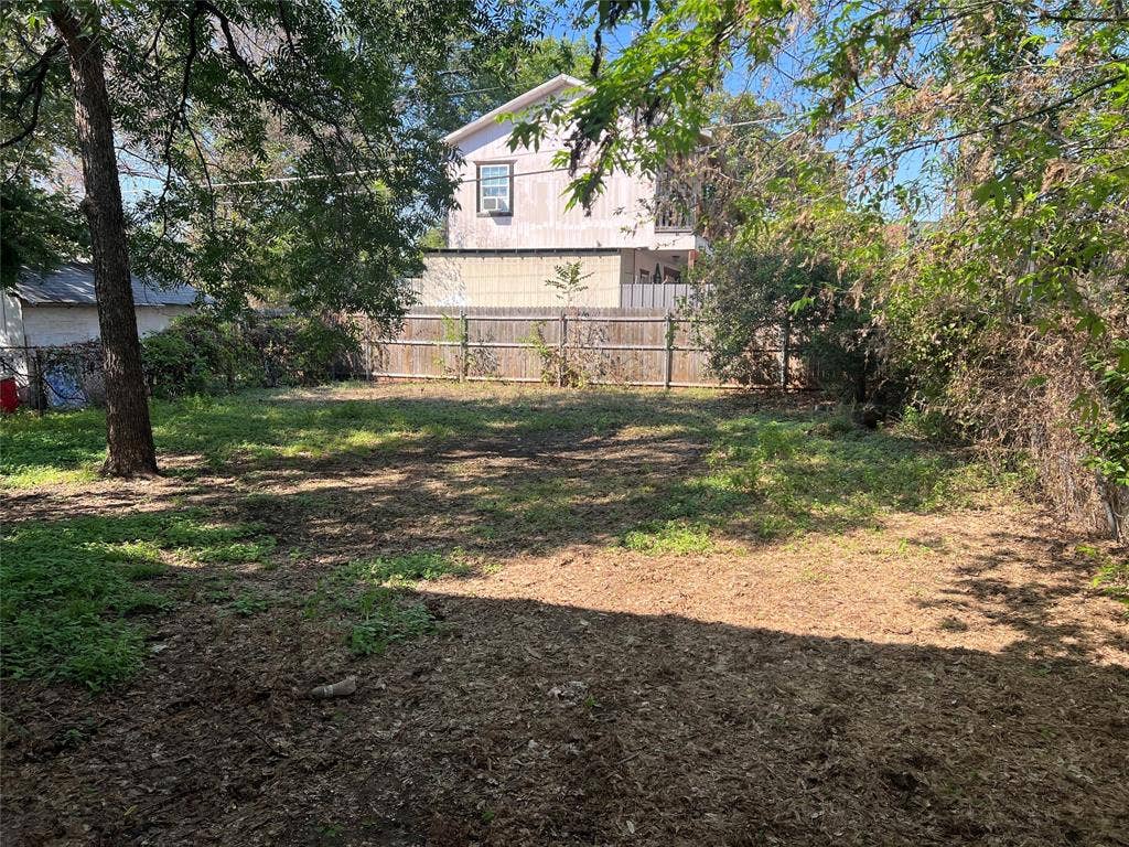 3227 Avenue I, Fort Worth, TX 76105 Expansive property lot featuring mature trees and wood fencing