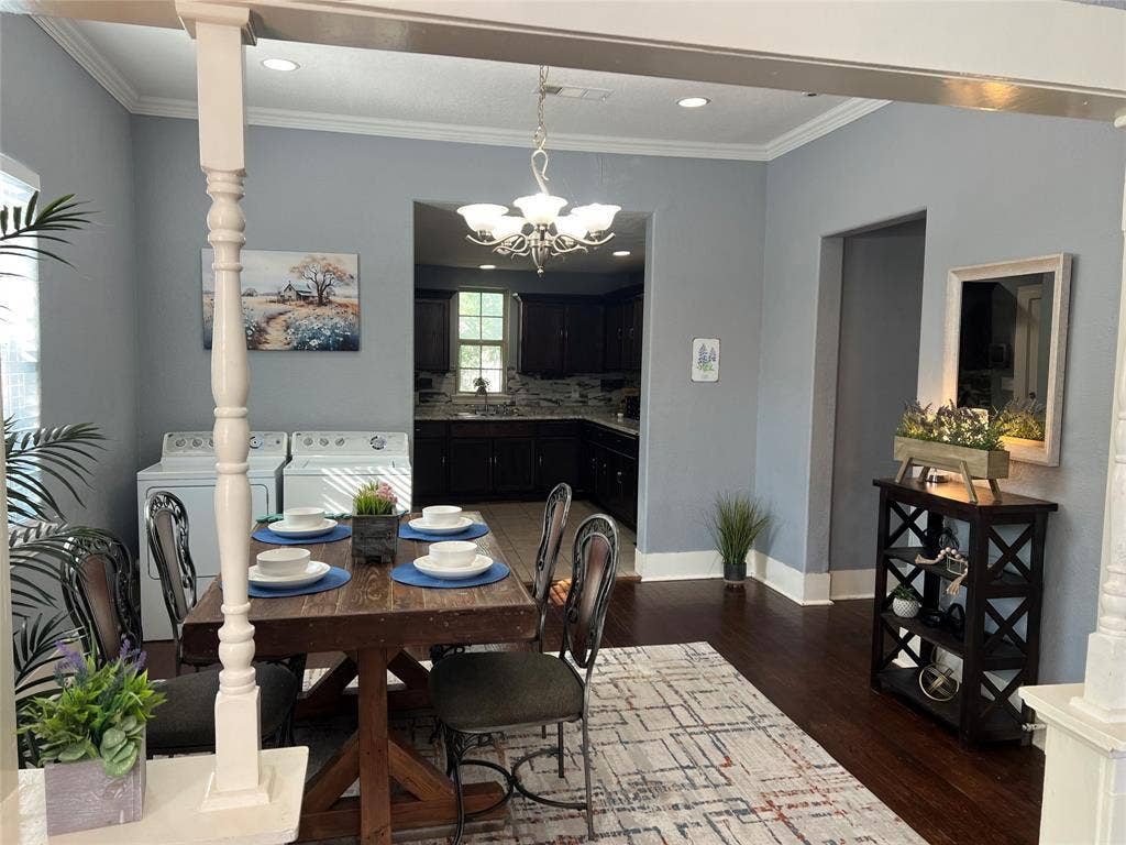 3227 Avenue I, Fort Worth, TX 76105 Hardwood flooring, crown molding, and a chandelier illuminate the space