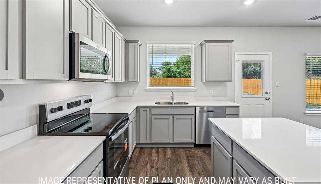 10408 Altair Drive, Waco, TX 76708 Modern kitchen with light grey cabinetry, white countertops, wood-finish flooring, stainless steel appliances, and recessed lighting