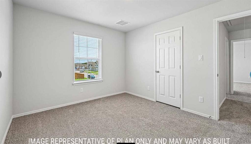 10408 Altair Drive, Waco, TX 76708 Light gray wall paint, textured carpeting, white trim, and a paneled interior door