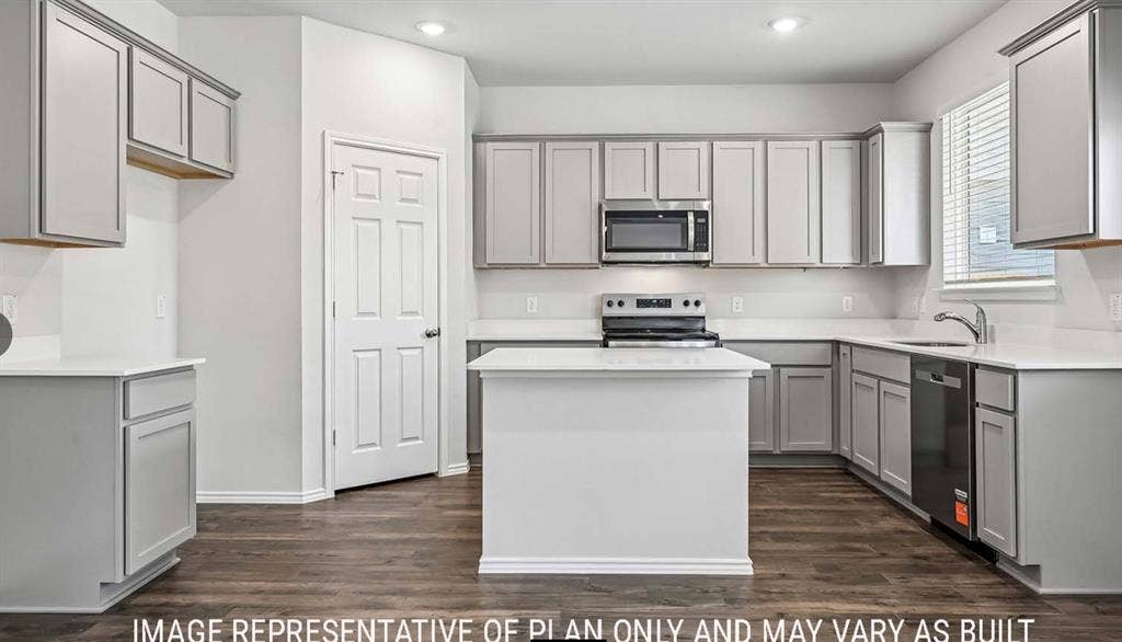 10408 Altair Drive, Waco, TX 76708 Kitchen featuring gray cabinetry, white countertops, a central island, wood-finish flooring, and stainless steel appliances