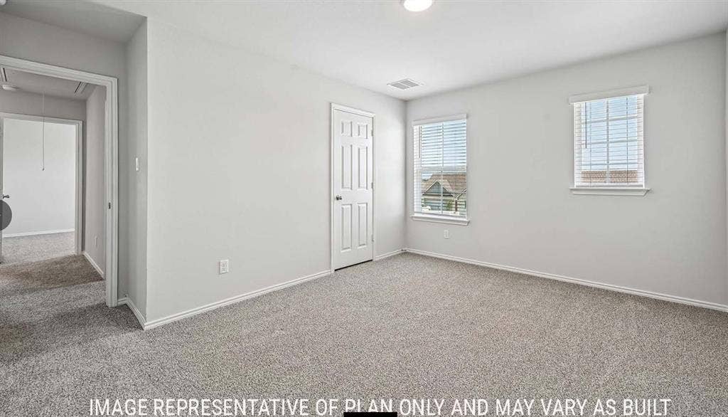 10408 Altair Drive, Waco, TX 76708 Neutral-toned walls, gray carpet flooring, two windows with blinds, a paneled door, and ceiling lighting