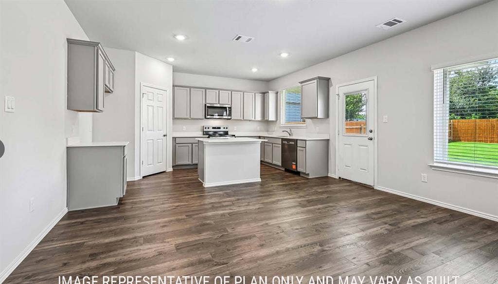 10408 Altair Drive, Waco, TX 76708 Open-concept kitchen and living area featuring wood-finish flooring, recessed lighting, and a kitchen island