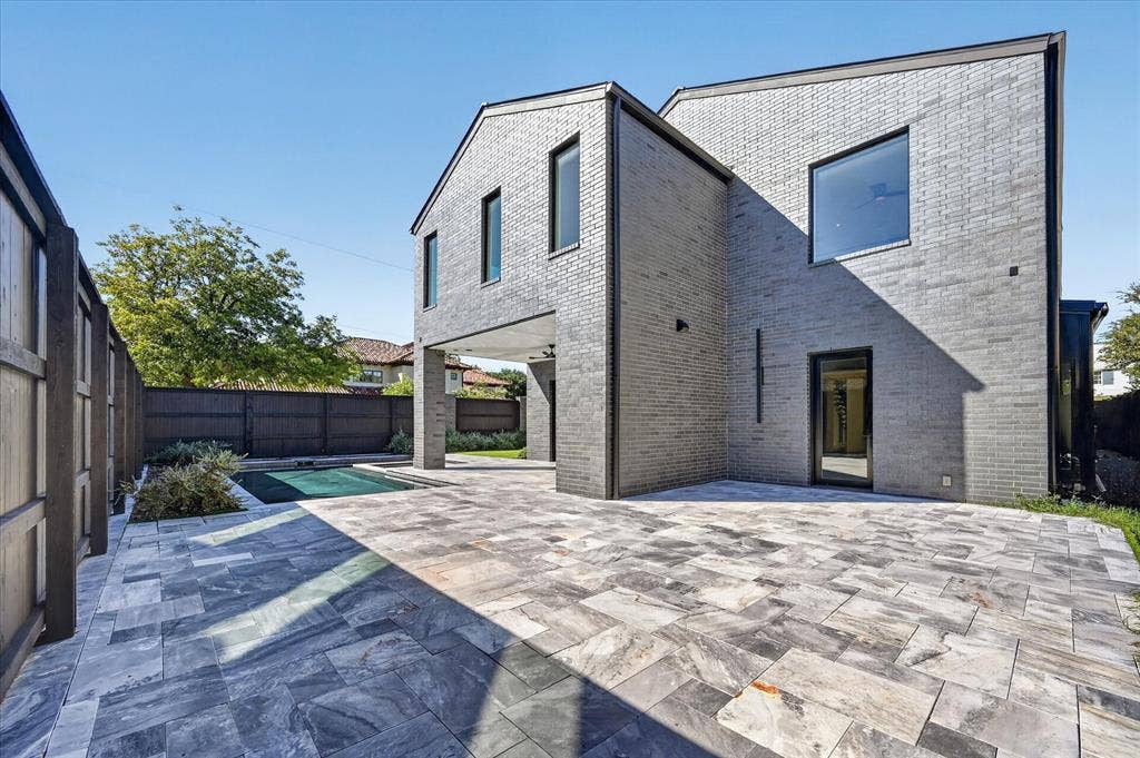 6404 Lakehurst Avenue, Dallas, TX 75230 Exterior featuring gray brick construction and dark frame windows