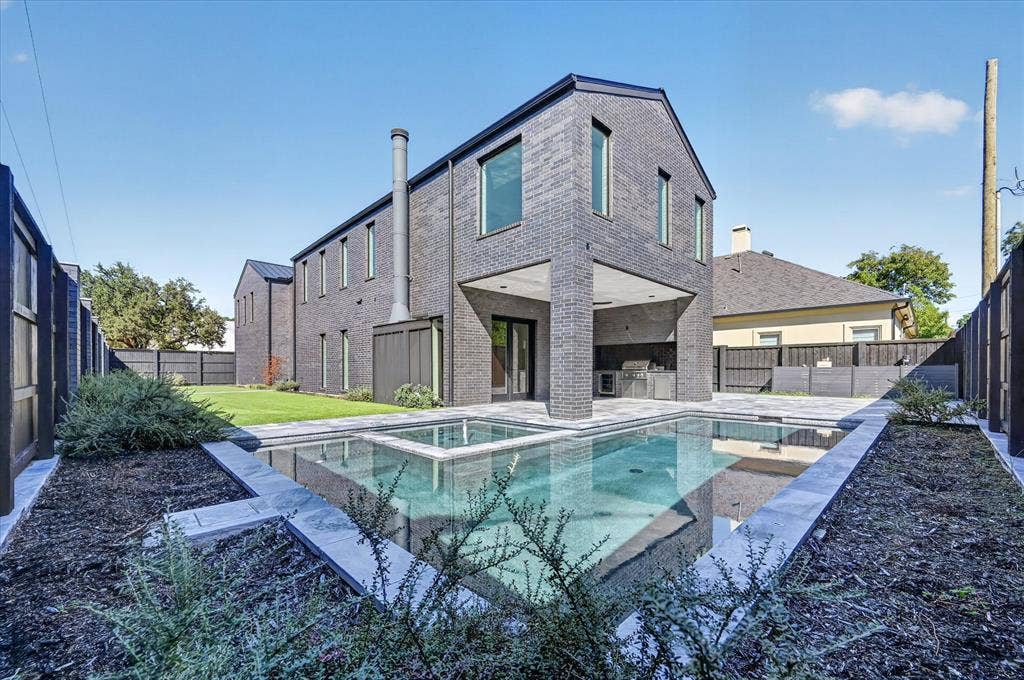 6404 Lakehurst Avenue, Dallas, TX 75230 Modern architectural design featuring dark brick masonry and an integrated outdoor kitchen