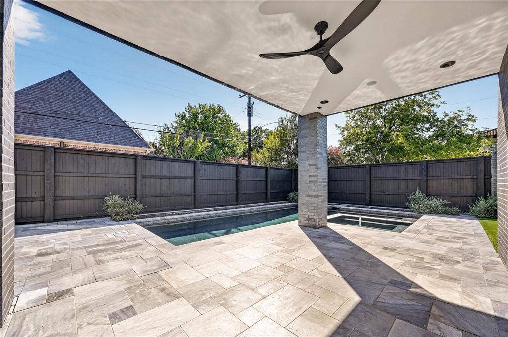 6404 Lakehurst Avenue, Dallas, TX 75230 Expansive outdoor patio featuring a covered area with a ceiling fan and recessed lighting, a built-in pool, and a spa