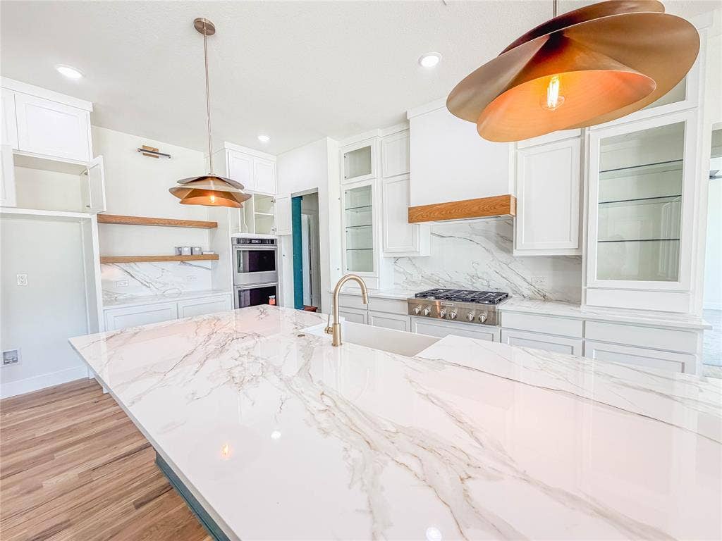 3860 Jacks Loop, Midlothian, TX 76065 Expansive kitchen island with a smooth, white countertop featuring intricate veining
