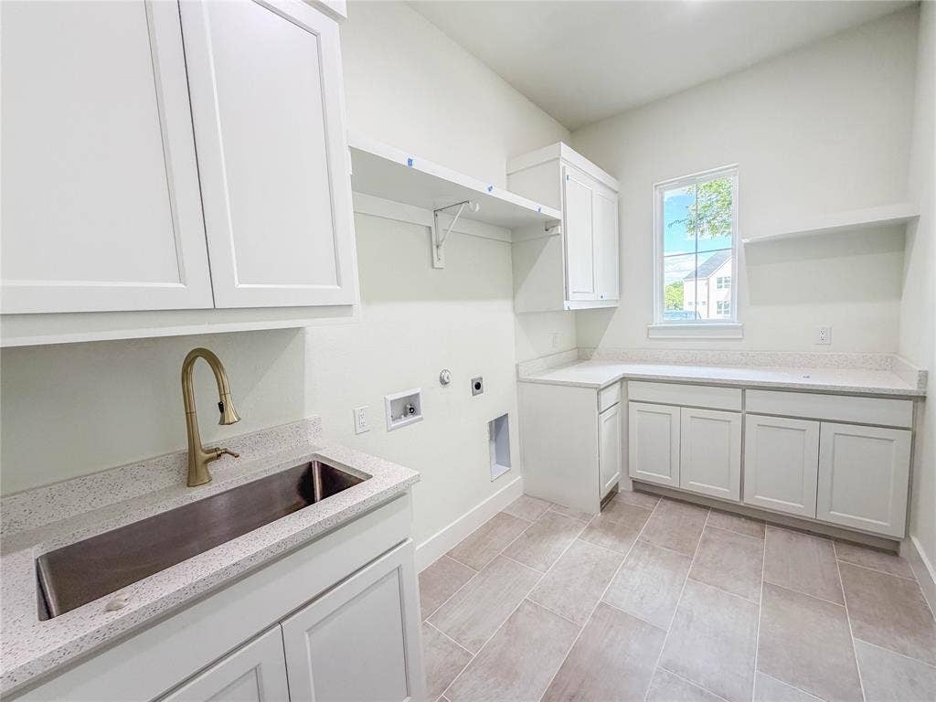 3860 Jacks Loop, Midlothian, TX 76065 White cabinetry with ample storage, integrated stainless steel sink, gold-finish faucet, light-toned countertops, and tile flooring
