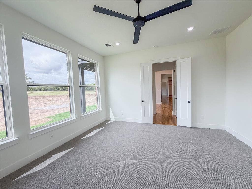 3860 Jacks Loop, Midlothian, TX 76065 Wall-to-wall carpeting, dual entry doors, multiple windows, recessed lighting, and a ceiling fan