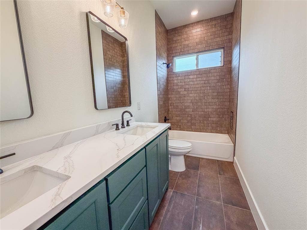 3860 Jacks Loop, Midlothian, TX 76065 Dual vanity with a white countertop and integrated sinks, dark green cabinetry, and rectangular mirrors