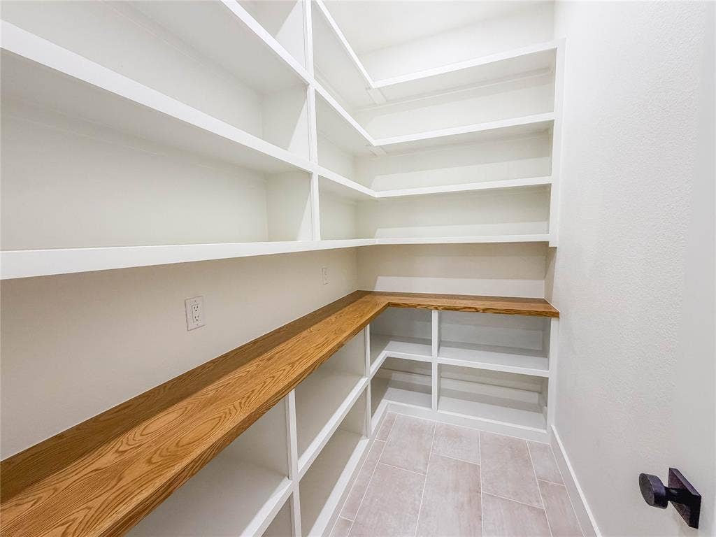 3860 Jacks Loop, Midlothian, TX 76065 Built-in shelving with white finishes, wood-finish countertop, and light-toned tile flooring
