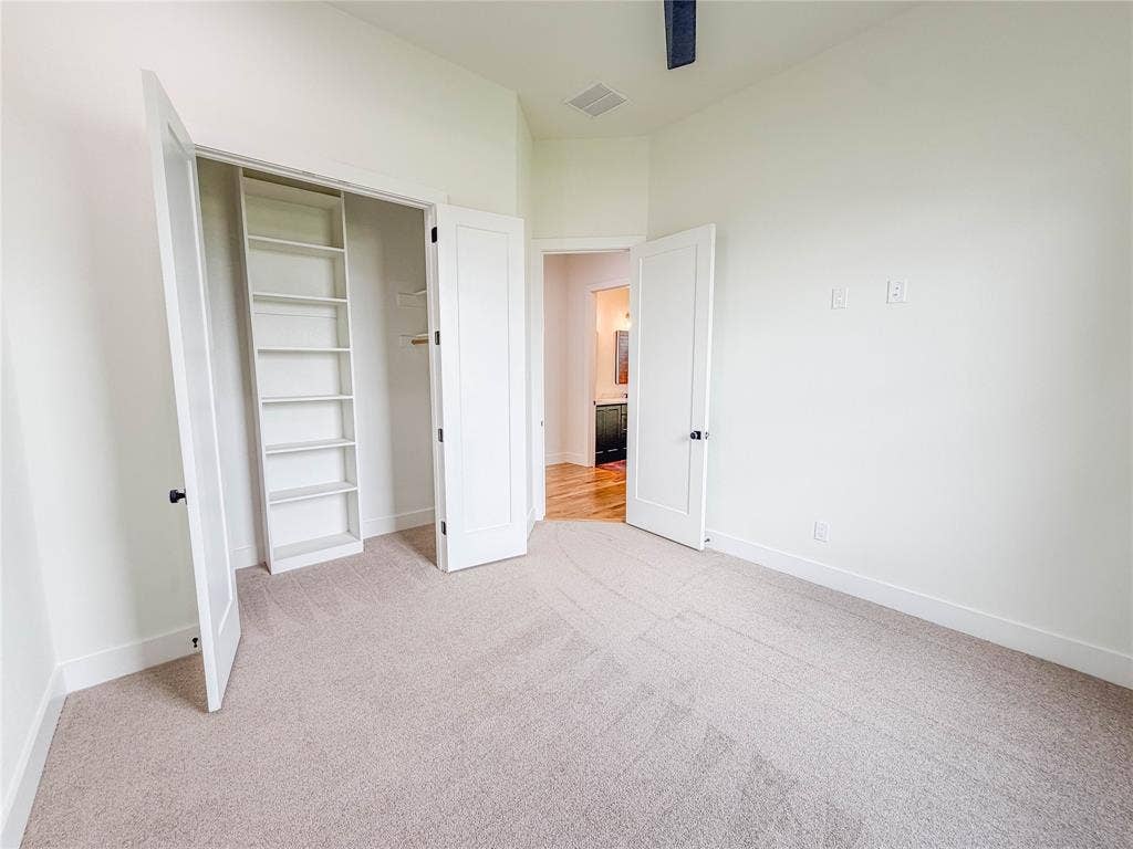 3860 Jacks Loop, Midlothian, TX 76065 Plush carpeted flooring, built-in shelving, white paneled doors, and painted white walls
