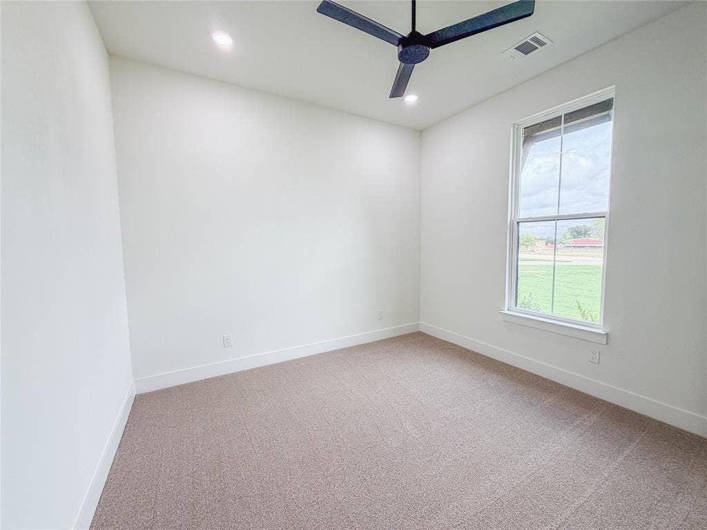 3860 Jacks Loop, Midlothian, TX 76065 Neutral tone carpet flooring, white painted walls, recessed ceiling lighting, a modern black ceiling fan, and a double-pane window