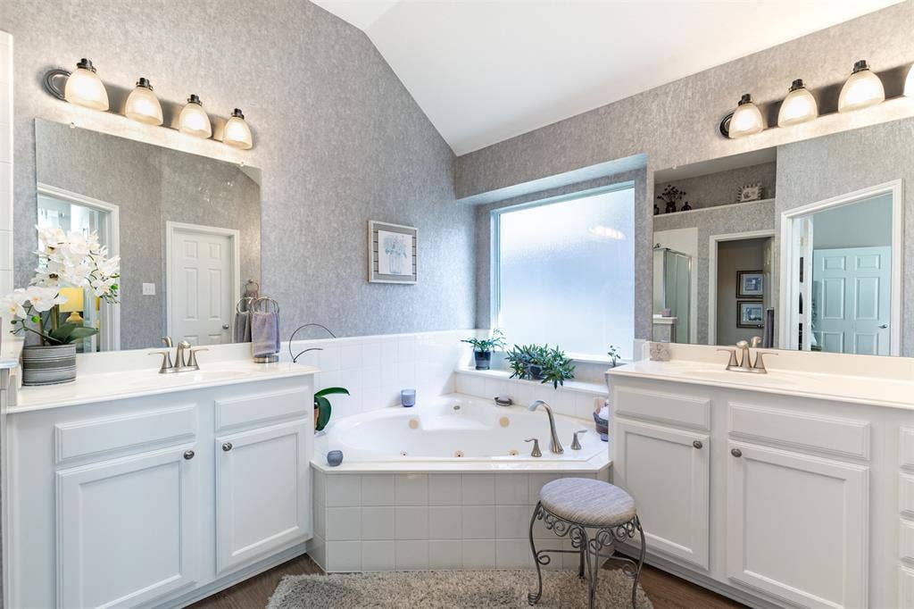 En-suite bath with dual vanities and jetted tub.