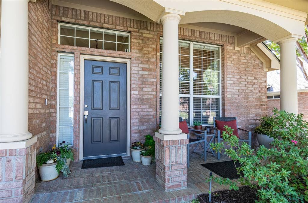 Cozy covered front porch warmly welcomes you inside.