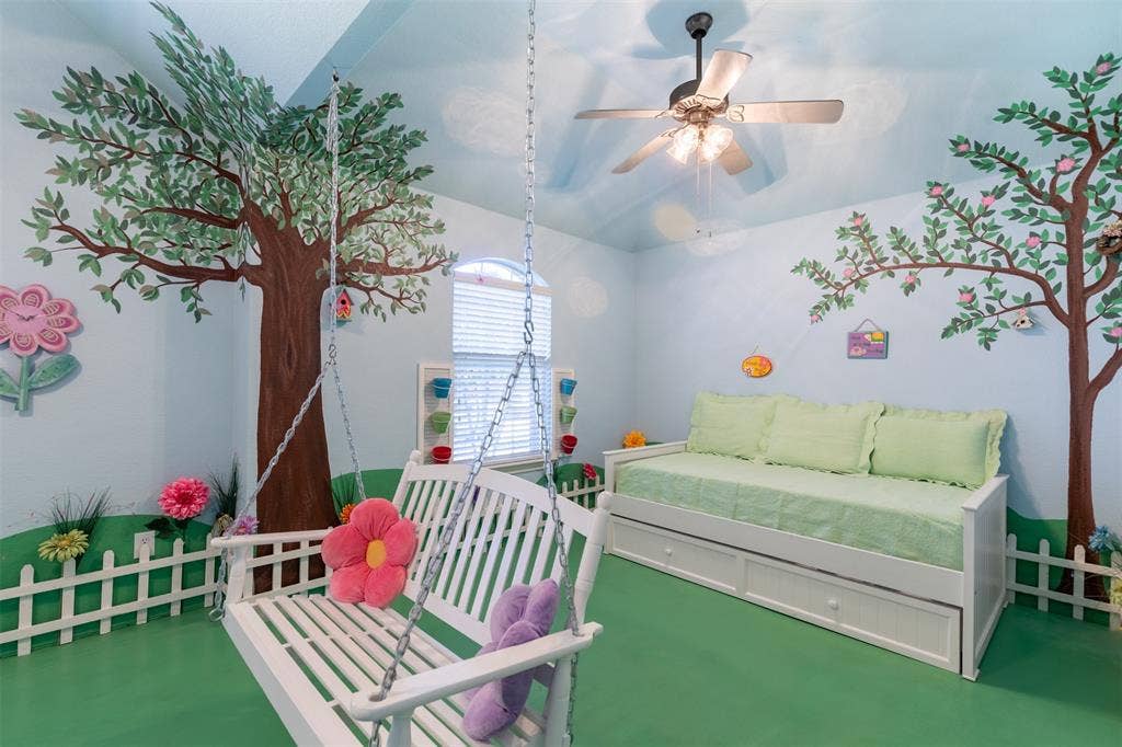 Oversized downstairs bedroom with ceiling fan.