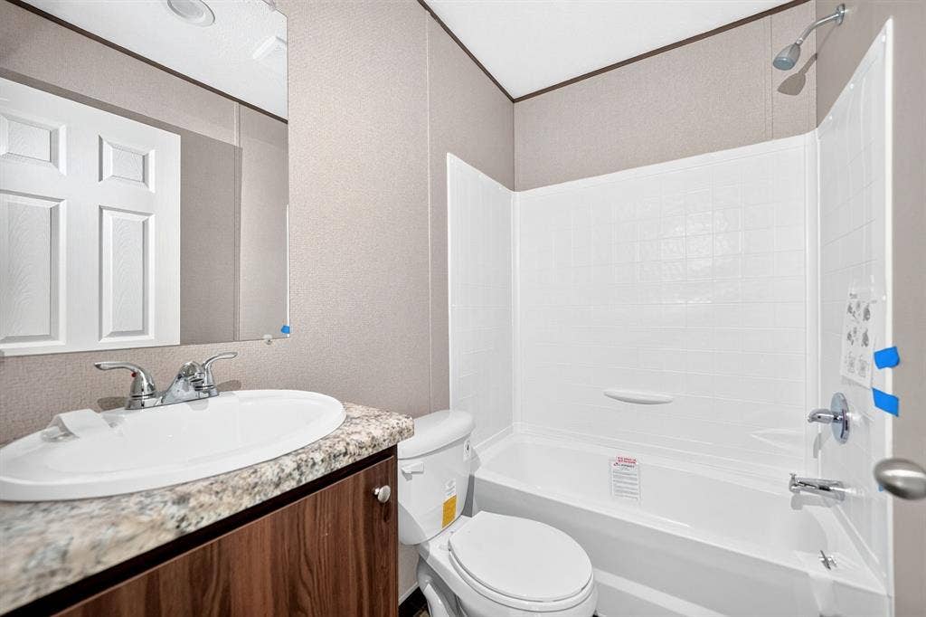 216 W Acres Road, Gun Barrel City, TX 75156 Bathroom featuring a vanity with a stone-finish countertop, undermount sink, and wood-finish cabinetry