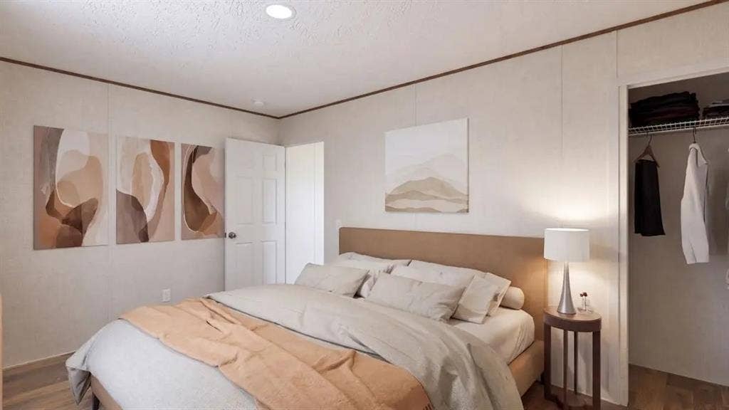 216 W Acres Road, Gun Barrel City, TX 75156 Bedroom featuring neutral-toned panel walls, wood-finish flooring, recessed ceiling lighting, and a reach-in closet with integrated shelving
