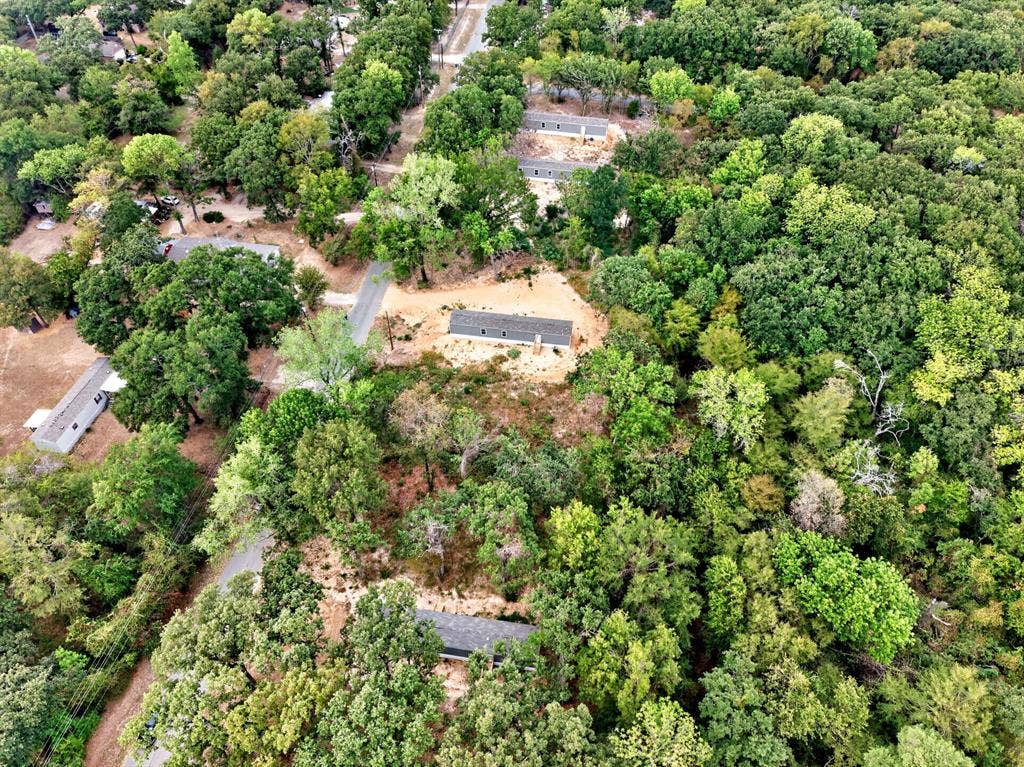 216 W Acres Road, Gun Barrel City, TX 75156 Wooded acreage featuring multiple residential structures and paved access