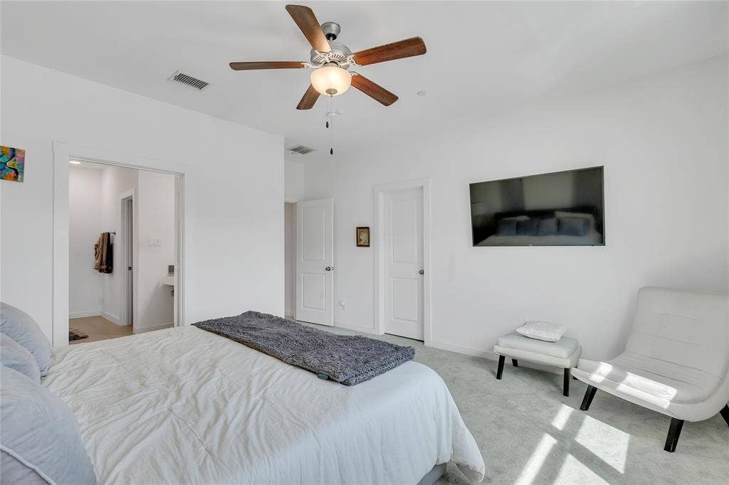 525 Division Street, Plano, TX 75075 Carpeted sleeping area with ceiling fan and attached lighting fixture