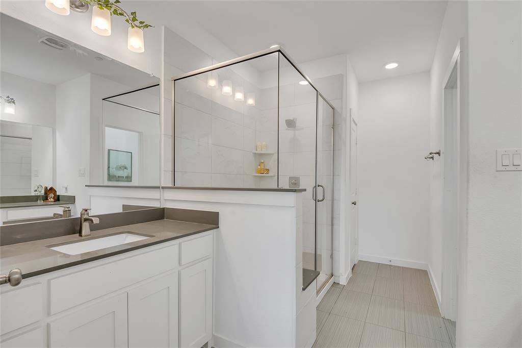 525 Division Street, Plano, TX 75075 White vanity with an integrated sink and brushed nickel faucet